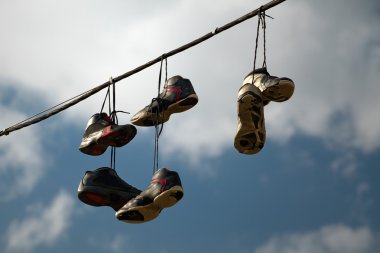 Sneakers Hanging on a Telephone Line clipart