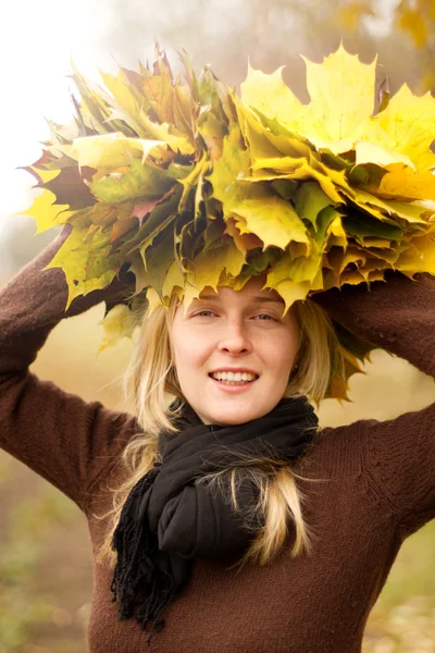Woman with autumn wreath outdoors Stock Photo