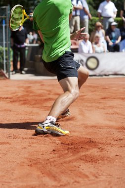 Male tennis player lunging for the ball clipart