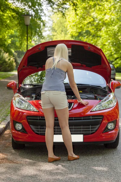 Ένα νεαρό κορίτσι με ένα κόκκινο αυτοκίνητο — Φωτογραφία Αρχείου