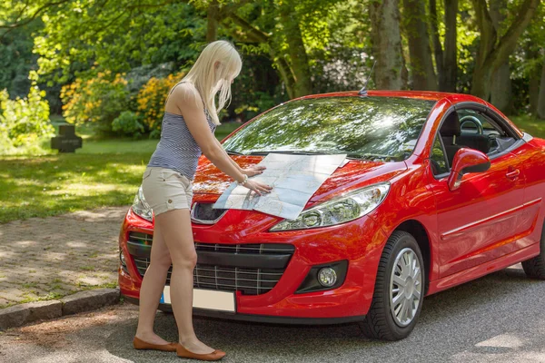A young girl with a red car — Stock Photo, Image