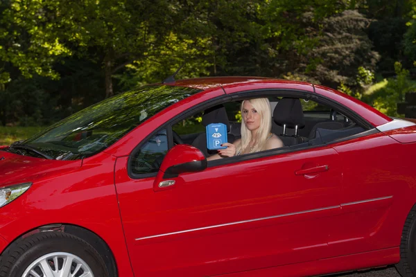 A young girl with a red car — Stock Photo, Image