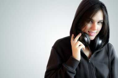 Beautiful Hip-Hop Style Girl Wearing a Hoddie Listening To Music clipart