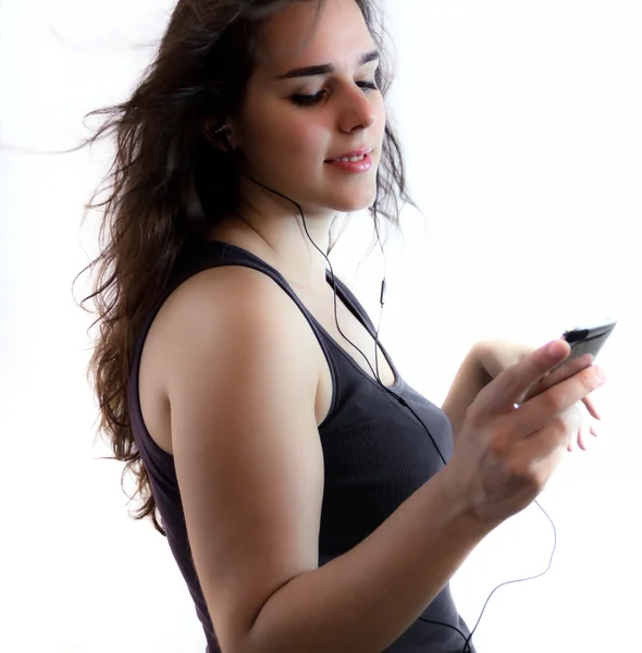 Young Girl Listening To Music from her music player — Stock Photo, Image