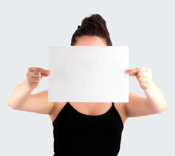 Young Casual Woman Holding a Blank Signboard - Paper with her tw — Stock Photo, Image
