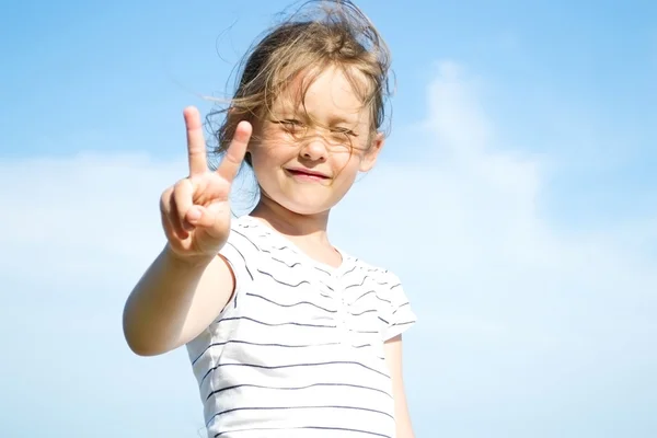 Girl shows a hand sign — Stock Photo, Image
