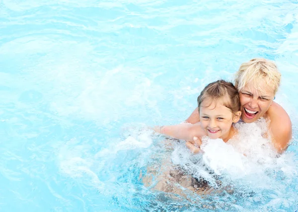 Woman and girl swimming in the pool — Stock Photo, Image
