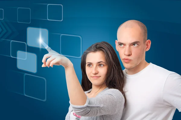 Couple clicking on a virtual touch screen interface — Stock Photo, Image