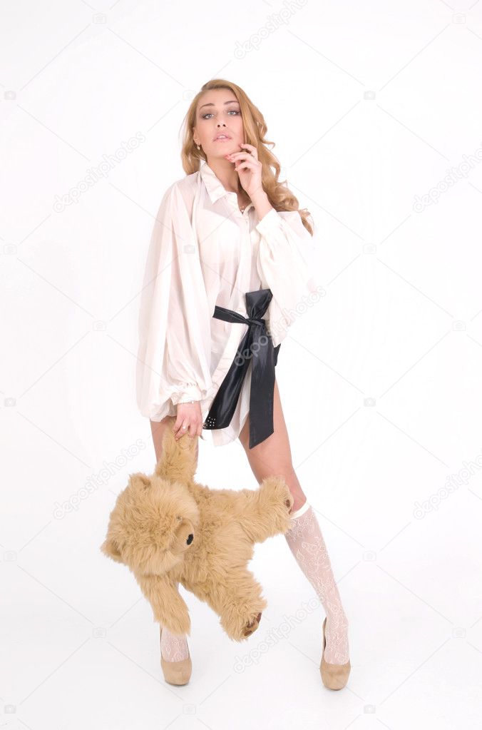 Fashion girl keeps the bear for paw and flirt