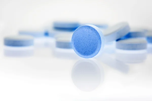 Blue round pills - Stock Photo, Image. 