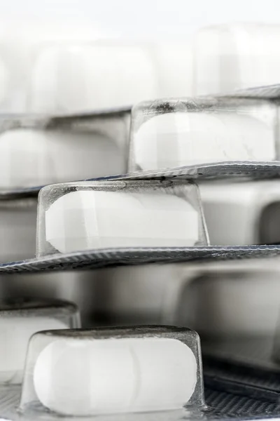 Blister packs of white pills vertical — Stock Photo, Image