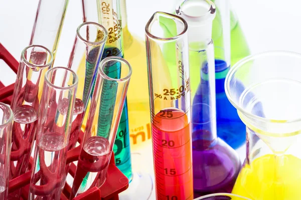 Laboratory glassware with various colored liquids — Stock Photo, Image
