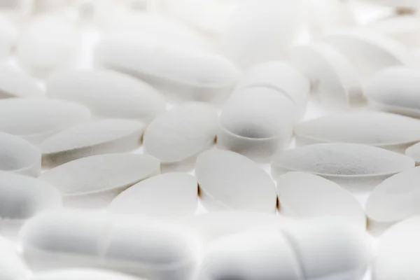 Various white pills with small DOF — Stock Photo, Image
