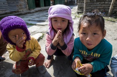 Sherpa children play in their village clipart