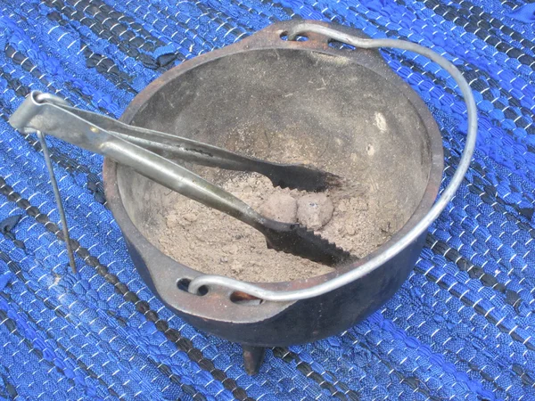 stock image Metal bowl for ashes with tongs on blue carpet, arabic tradition