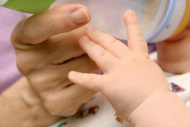 Hands of baby and grandma clipart