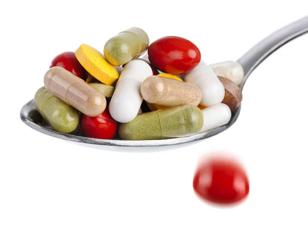 Spoon piled with pills — Stock Photo, Image