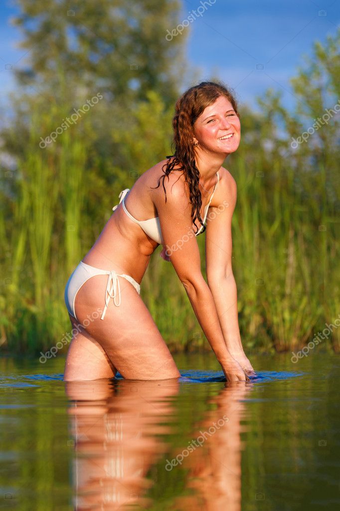 Stretching Girl in Bikini into Lake Stock Photo - Image of fashion, cute:  58105686