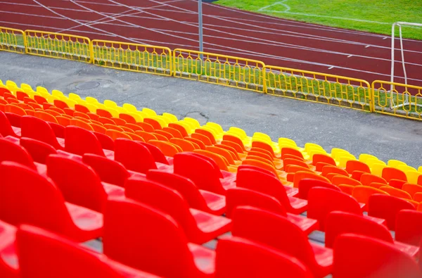 stock image Close up of rows of red orange and yellow stadium chairs