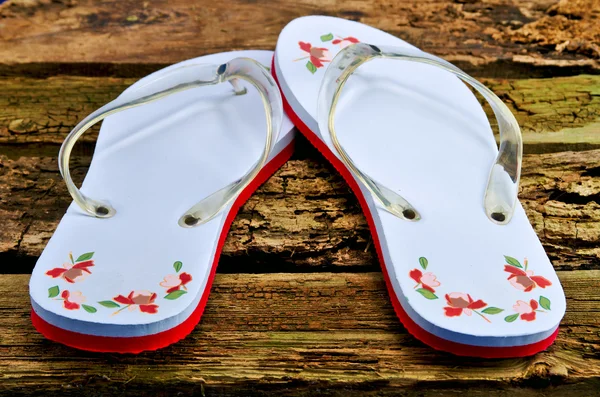 stock image Flip flops on worn wooden floor