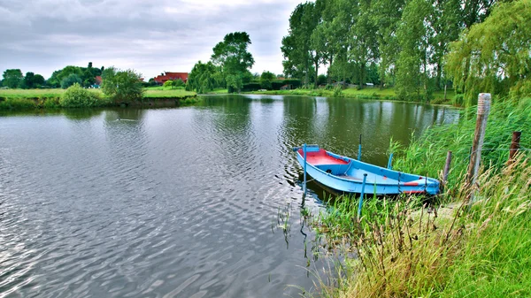 stock image Slow River and a Blue Boat