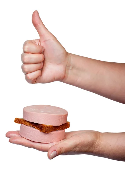 Sandwich with boiled sausage lying on a palm — Stock Photo, Image