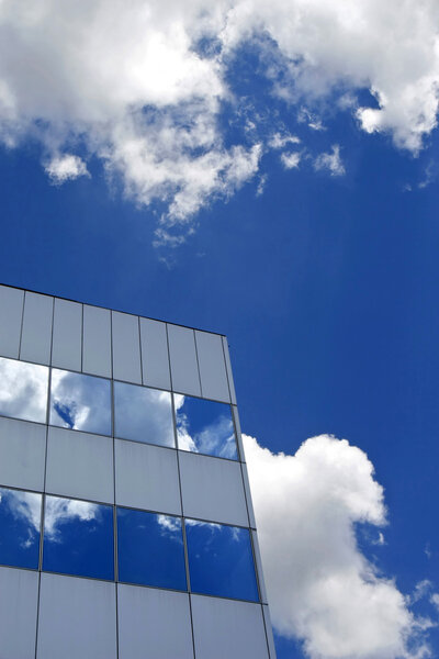 Detail of office building and deep blue sky and white clouds