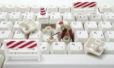 Miniature toy workers repairing computer keyboard clipart