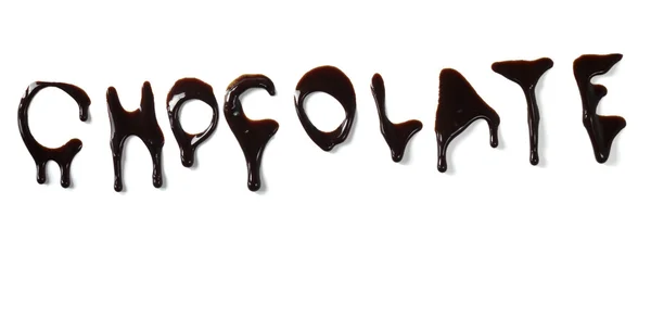 Шоколадный сироп просачивается жидкими сладкими письмами — стоковое фото