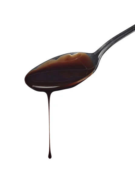 Spoon preperation kitchen tool food chocolate syrup leaking — Stock Photo, Image