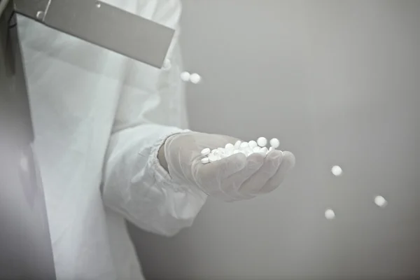 Stock image Hand with gloves and pills