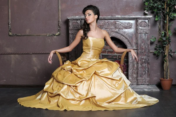 Beautiful girl in golden dress — Stock Photo, Image