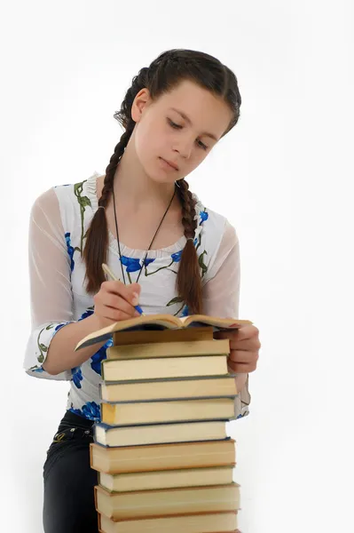 Мила молода жінка зі стопкою книг — стокове фото
