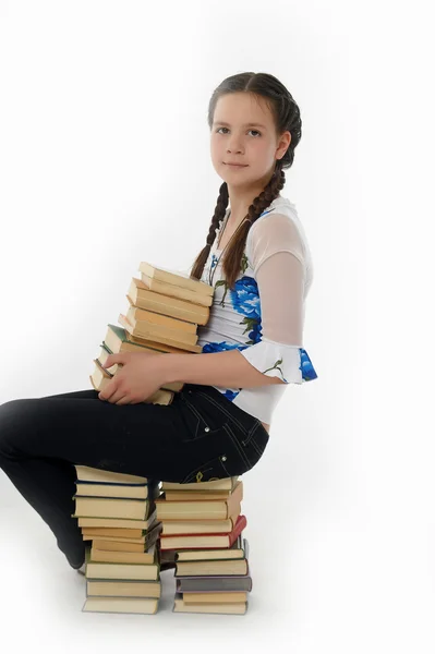 Χαριτωμένο νεαρές με μια στοίβα από βιβλία — Φωτογραφία Αρχείου