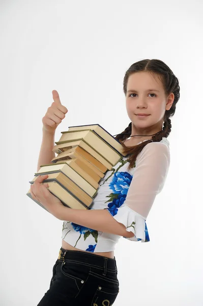 Aranyos fiatal nő-val egy halom könyvet — Stock Fotó