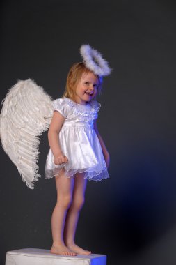 Baby girl in an angel dress clipart