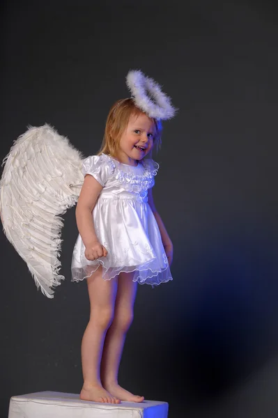 Baby girl in an angel dress — Stock Photo, Image