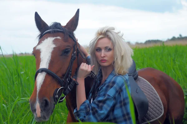 Sexy blonde naast het paard — Stockfoto