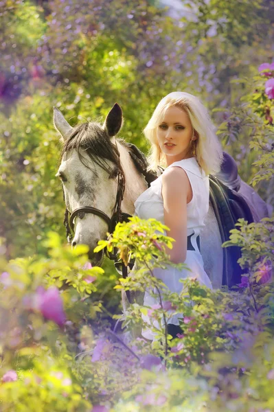 Blonde girl with a horse — Stock Photo, Image