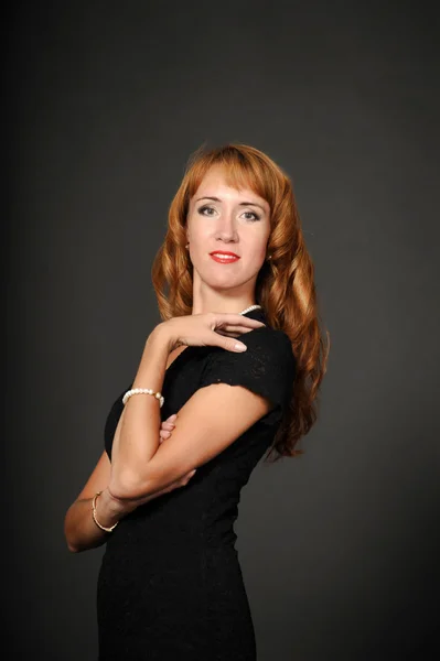 Portrait of red-haired girl in a black dress — Stock Photo, Image