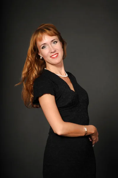 Portrait of red-haired girl in a black dress — Stock Photo, Image
