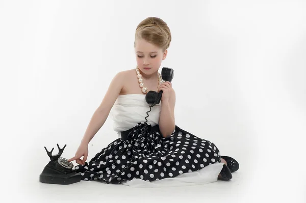Little girl with a retro phone — Stock Photo, Image