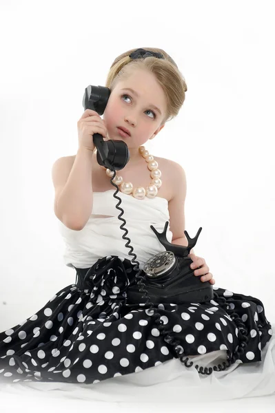 Little girl with a retro phone — Stock Photo, Image