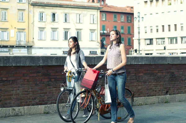 Two Girls While they make shopping in bicycle to Pisa