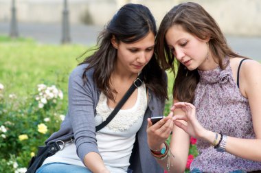 bir telefon bir konuşmasını yaparken iki kız