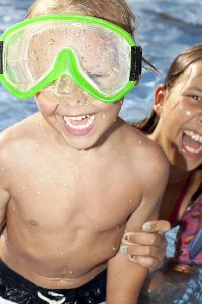 Positivo menino e menina sre na piscina — Fotografia de Stock