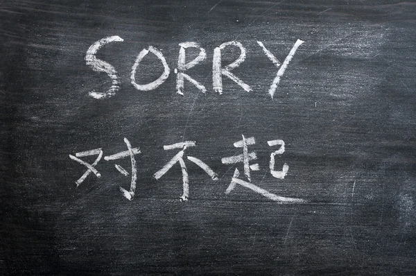 Sorry - woord geschreven op een vlekkerig schoolbord — Stockfoto