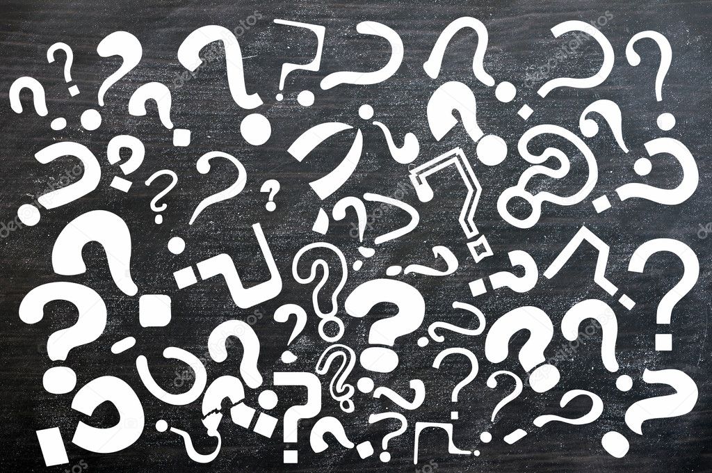 Various question marks on a blackboard