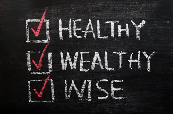 Being healthy, wealthy and wise written with chalk on a blackboard — Stock Photo, Image