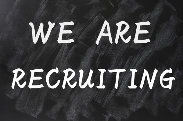 Concept of we are recruiting written on smudged blackboard background — Stock Photo, Image